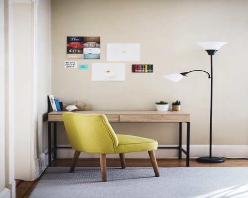 Cozy reading corner with a warm lamp in a modern living room at dusk